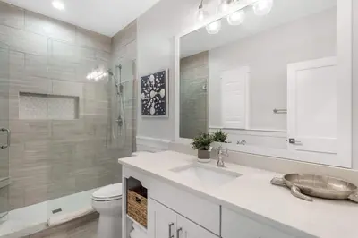 a white bathroom with a sink and a toilet at The Crab House Golf Cart Bikes in Seacrest