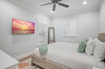 a bedroom with a bed and a ceiling fan at The Crab House Golf Cart Bikes in Seacrest