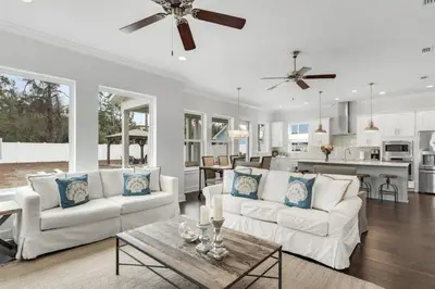 a living room with two white couches and a table at Sea Change At Eastern Lake Private Pool in Watersound Beach