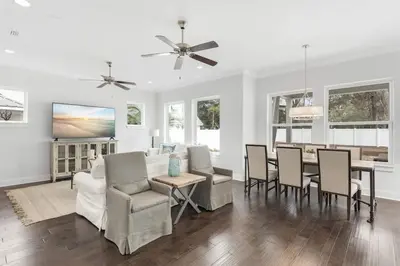 a dining room and living room with a table and chairs at Sea Change At Eastern Lake Private Pool in Watersound Beach