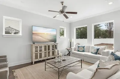 a living room with a couch and a tv at Sea Change At Eastern Lake Private Pool in Watersound Beach