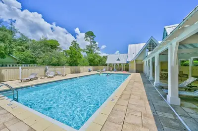 a swimming pool in the backyard of a house at A Wave From It All Bikes Lake Grill in Inlet Beach