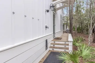 a porch of a white house with stairs at Shore Me The Way Close To Beach Bikes in Seacrest