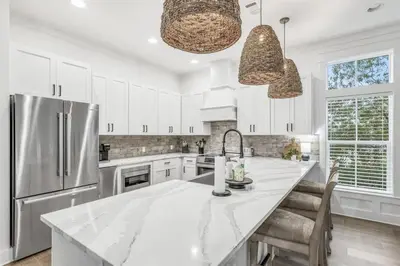 a kitchen with white cabinets and a large kitchen island at Shore Me The Way Close To Beach Bikes in Seacrest