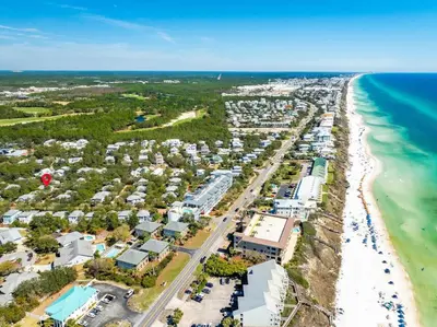 an aerial view of a beach with condos and the ocean at The Story House Walk To Beach Pet Friendly in Seacrest