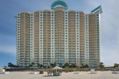 a large building on the beach with a beach at Aqua Resort 1111 by Emerald Coast Retreats in Panama City Beach