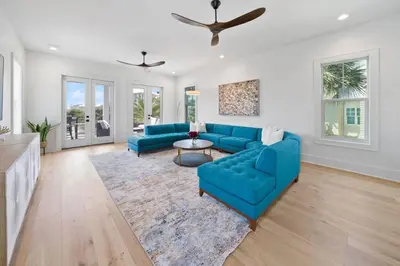 a living room with two blue couches and a rug at Big Beach Watch near beach private pool sleeps 21 in Santa Rosa Beach