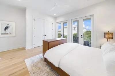 a white bedroom with a large bed and a window at Big Beach Watch near beach private pool sleeps 21 in Santa Rosa Beach