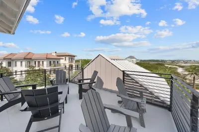 a balcony with chairs and a view of the beach at Big Beach Watch near beach private pool sleeps 21 in Santa Rosa Beach