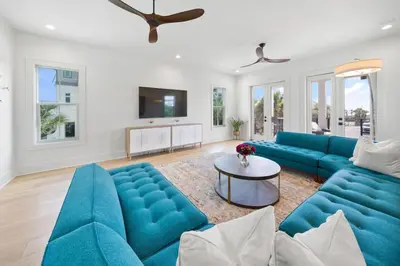 a living room with blue couches and a table at Big Beach Watch near beach private pool sleeps 21 in Santa Rosa Beach