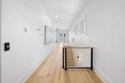 a hallway with a table in the middle of a room at Big Beach Watch near beach private pool sleeps 21 in Santa Rosa Beach