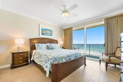 a bedroom with a bed and a view of the ocean at Boardwalk 501 in Panama City Beach