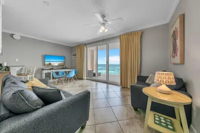a living room with a couch and a table at Twin Palms 603 in Panama City Beach