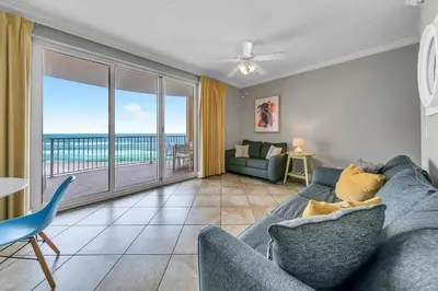 a living room with a couch and a view of the ocean at Twin Palms 603 in Panama City Beach