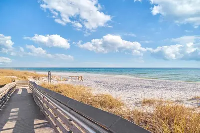 a boardwalk to the beach with the ocean in the background at New Pool 5 Bedroom Screened Porch in Inlet Beach