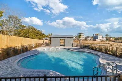 a swimming pool in a backyard with a fence at New Pool 5 Bedroom Screened Porch in Inlet Beach