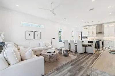 a white living room with a white couch and a table at New Pool 5 Bedroom Screened Porch in Inlet Beach