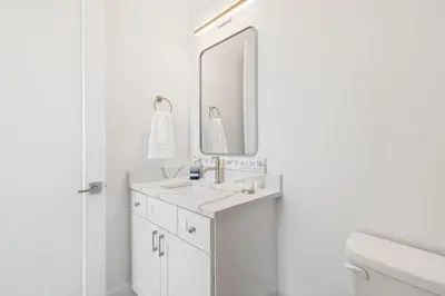 a white bathroom with a sink and a mirror at New Pool 5 Bedroom Screened Porch in Inlet Beach