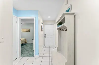 a hallway with a door leading to a bedroom at Endless Summer #D1 in Panama City Beach