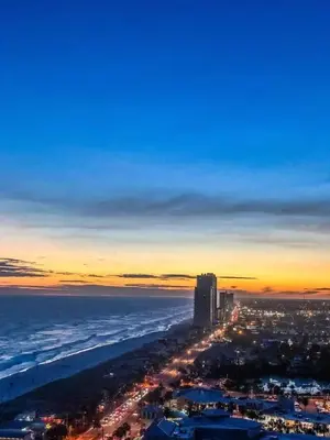 a view of a beach at night with a city at Calypso 1204E in Panama City Beach