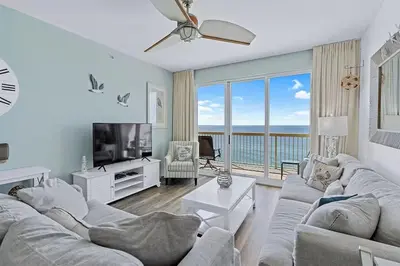 a living room with a couch and a tv at Calypso 1204E in Panama City Beach