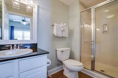 a bathroom with a toilet and a sink and a shower at Calypso 1401E in Panama City Beach
