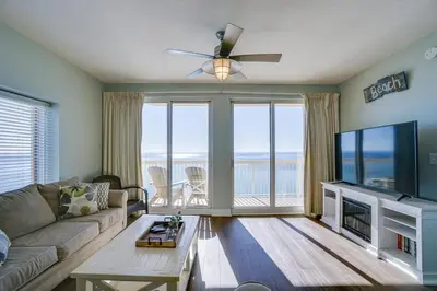 a living room with a couch and a flat screen tv at Calypso 1401E in Panama City Beach