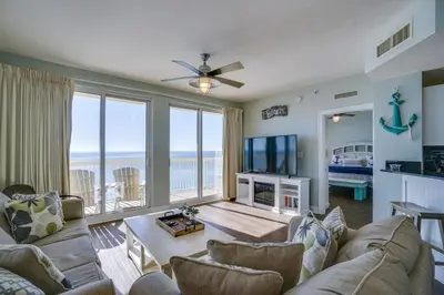 a living room with a couch and a tv at Calypso 1401E in Panama City Beach
