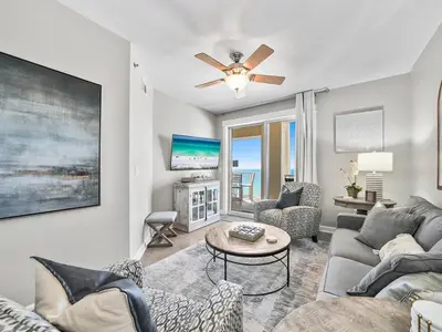 a living room with a couch and a ceiling fan at Grand Panama 1101 in Panama City Beach