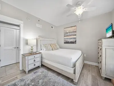a bedroom with a bed and a ceiling fan at Grand Panama 1101 in Panama City Beach