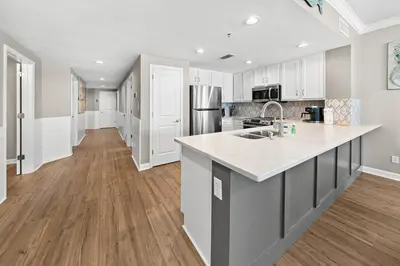 a kitchen with white cabinets and a counter top at Grandview East 101 in Panama City Beach