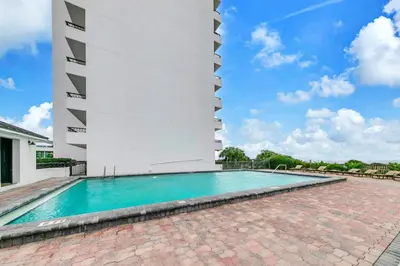 a swimming pool in front of a building at One Seagrove Place 702 Gulf-front unit sleeps 6 in Santa Rosa Beach