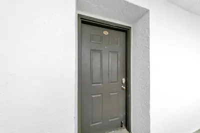 a gray door in a white wall with a door sidx sidx at One Seagrove Place 702 Gulf-front unit sleeps 6 in Santa Rosa Beach