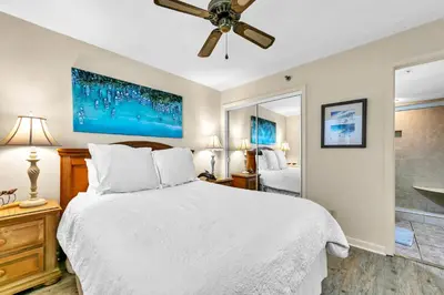 a bedroom with a bed and a ceiling fan at One Seagrove Place 702 Gulf-front unit sleeps 6 in Santa Rosa Beach