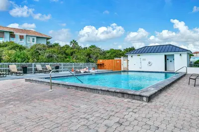 a swimming pool with blue water in a yard at One Seagrove Place 702 Gulf-front unit sleeps 6 in Santa Rosa Beach