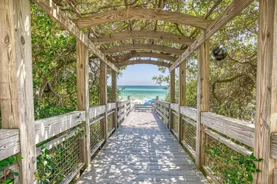a wooden bridge over a beach with the ocean in the background at One Seagrove Place 702 Gulf-front unit sleeps 6 in Santa Rosa Beach