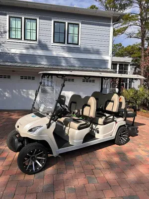a golf cart parked in front of a house at Caspian Blue Paradise 30A Luxe Retreat in Seacrest