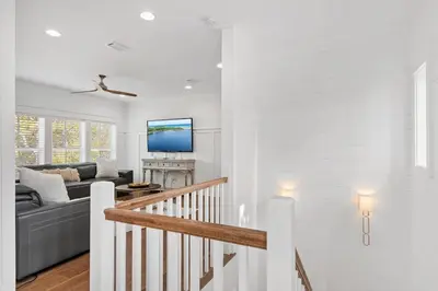 a white living room with a couch and a tv at Caspian Blue Paradise 30A Luxe Retreat in Seacrest