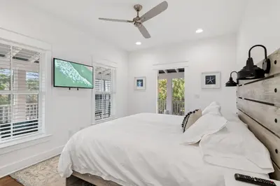 a white bedroom with a bed and a ceiling fan at Caspian Blue Paradise 30A Luxe Retreat in Seacrest