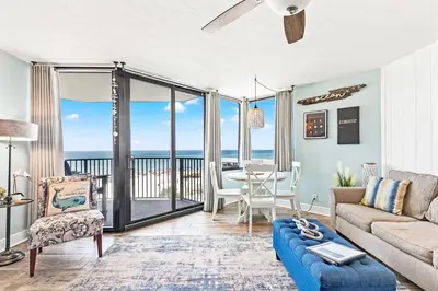 a living room with a view of the ocean at Pelican's Perch at the Sunbird in Panama City Beach