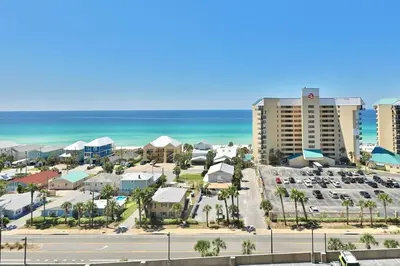 a view of a city with a parking lot and the ocean at Pelican's Perch at the Sunbird in Panama City Beach