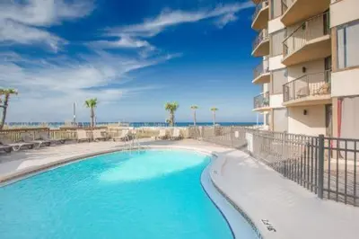 a large swimming pool in front of a building at Pelican's Perch at the Sunbird in Panama City Beach