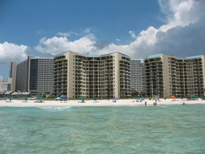 a large hotel on the beach with the ocean at Pelican's Perch at the Sunbird in Panama City Beach