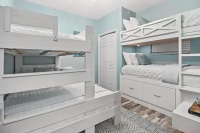 a bedroom with two bunk beds and a bed at Beach front close to attractions condo- Zenwave Retreat in Panama City Beach