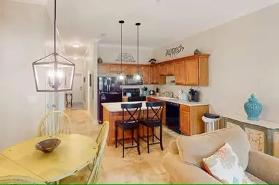 a kitchen and living room with a table and chairs at Seagrove Highlands 1304 in Santa Rosa Beach
