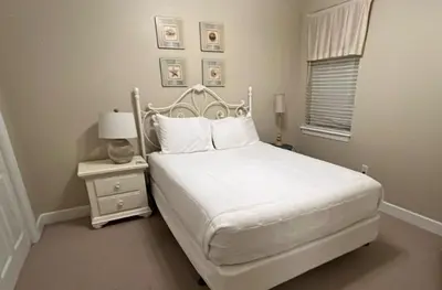 a white bedroom with a white bed and a nightstand at Seagrove Highlands 1304 in Santa Rosa Beach