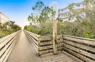 a wooden pedestrian bridge over a boardwalk at Seagrove Highlands 1304 in Santa Rosa Beach