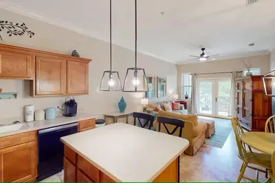 a kitchen and living room with a couch and a table at Seagrove Highlands 1304 in Santa Rosa Beach