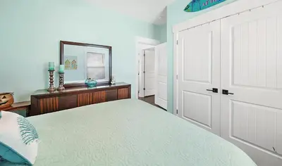 a bedroom with a bed and a large white door at Lah De Dah by Emerald Coast Retreats in Panama City Beach