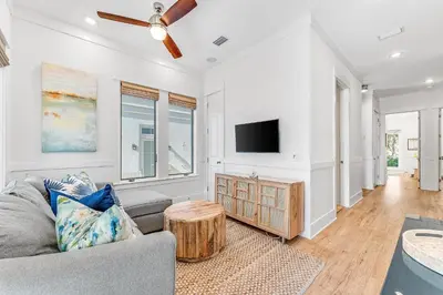 a living room with a couch and a tv at Sand On Tap in Inlet Beach